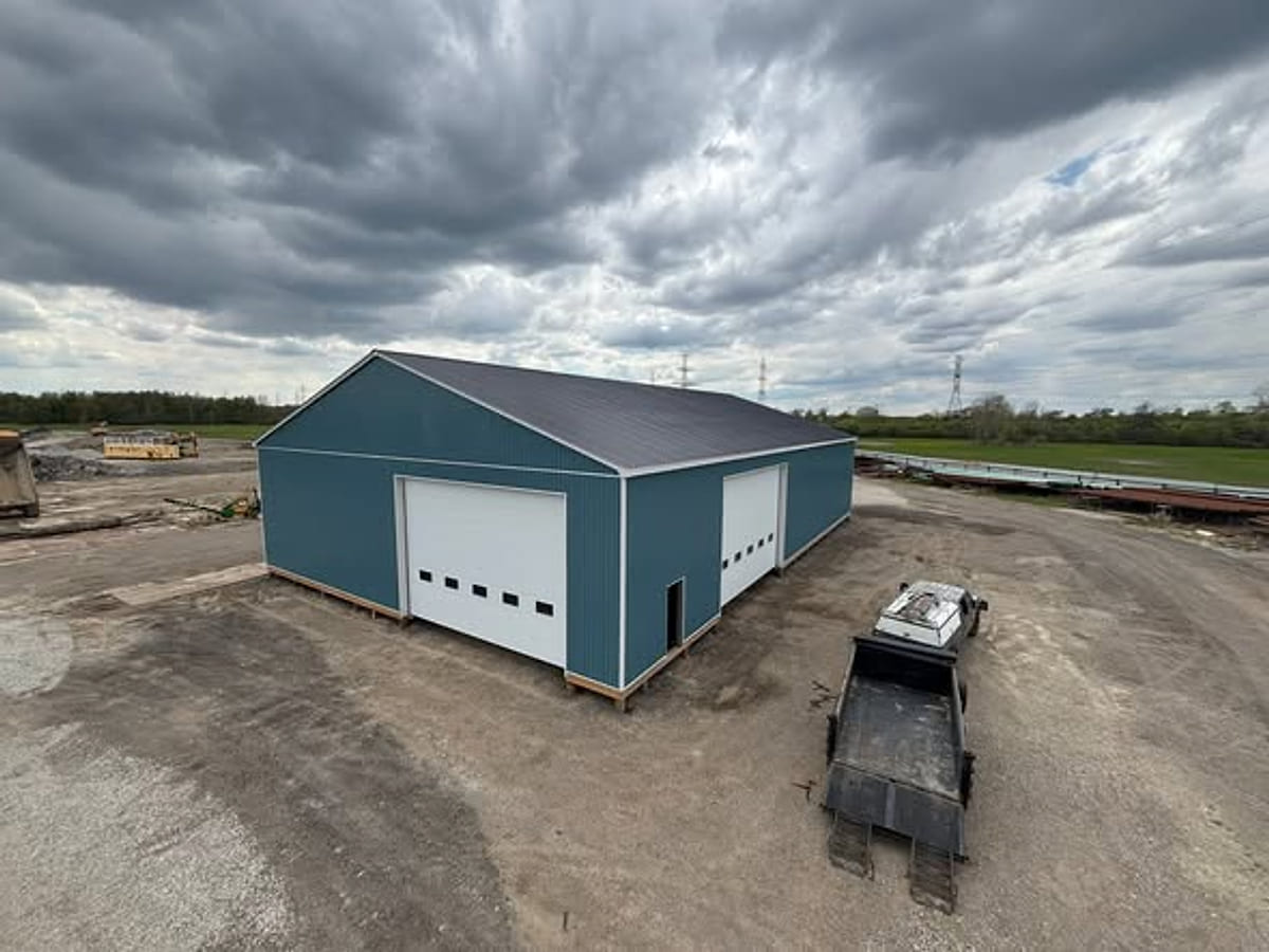 A TKC steel-clad shop building with overhead doors