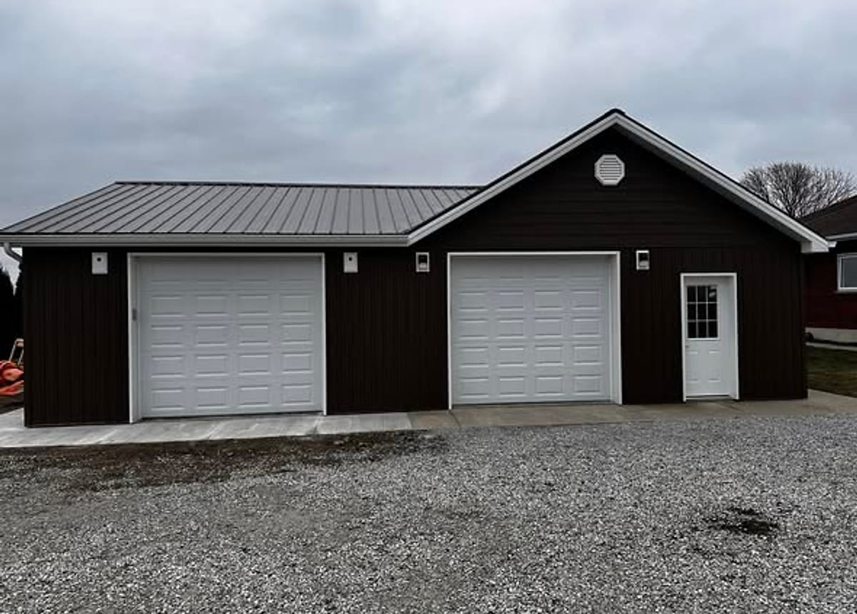 A detached garage with two overhead doors